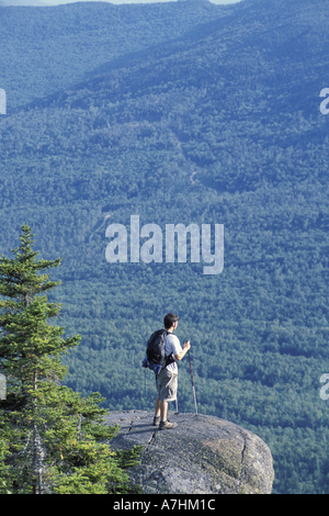 North America, US, ME, A hiker stands on a ledge near the west peak of Tumbledown Mountain. Northern Forest. (MR) Stock Photo
