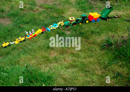 children's toy train trucks and cars on the grass Stock Photo