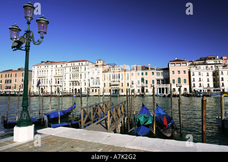 Typical view of Venetian gondolas on Grand Canal near St Marks Square with ornate iron lamp post Venice Italy Europe EU Stock Photo