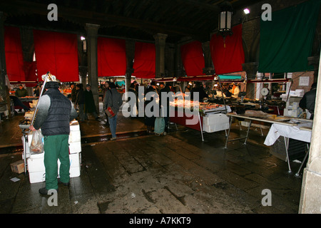 Local Venetian residents buy fresh fish from this ancient fish market near the Rialto Bridge, Venice Italy Europe EU Stock Photo