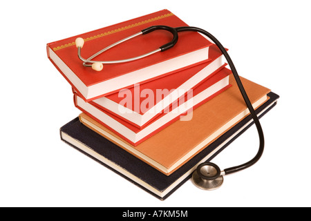 Stethoscope on a stack of reference books isolated on white Stock Photo