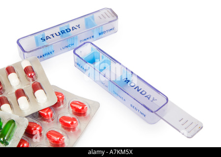 Pill boxes indicating days of the week with pills isolated on white Stock Photo