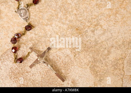 Rosary beads on a sandstone background Stock Photo