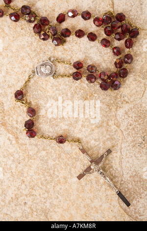 Rosary beads on a sandstone background Stock Photo