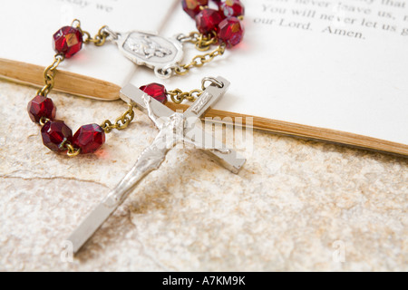 Rosary beads on a book of psalms and sandstone background Stock Photo