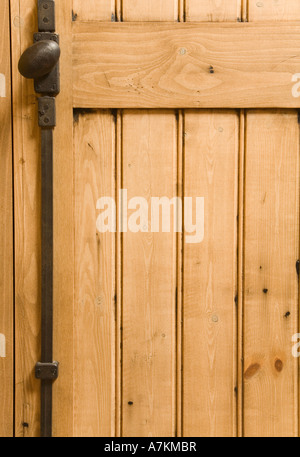 Detail of wooden panelled furniture with iron handle Stock Photo