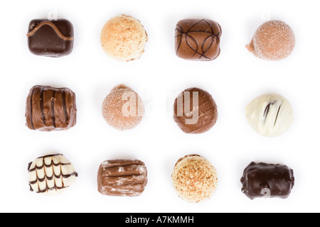 Individual chocolates in a uniform pattern isolated on white Stock Photo