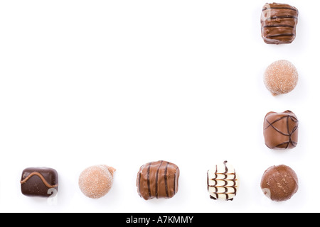 Border of individual chocolates isolated on white with copy space Stock Photo