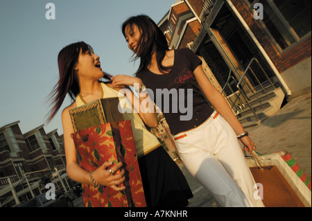 Chinese young women walking in street Stock Photo
