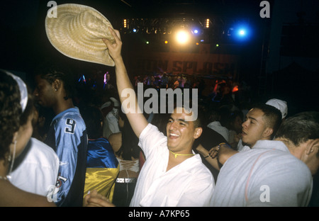 A latino man raises his hat at a salsa concert, Latin Splash 2003 on Clapham Common Stock Photo