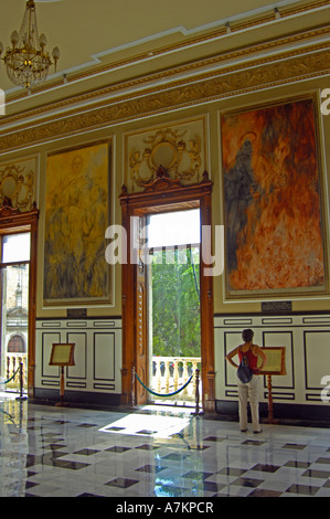 A single woman in the art gallery of the Gobierno Palace Stock Photo