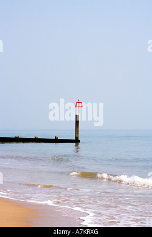 Groyne with red warning marker and seagull.  Bournemouth beach. Dorset. UK. Stock Photo