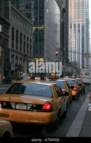 Yellow taxi cabs. Manhattan, New York city . Waiting in line for fares. Early morning. USA. Winter. Rear view. Stock Photo