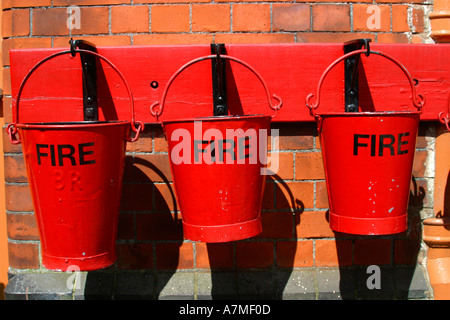 Red fire buckets filled with sand Stock Photo