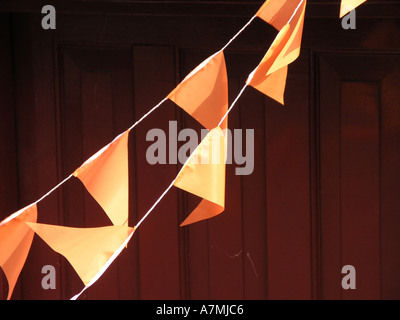 Orange flags on a string in Amsterdam - used during Queens Day celebrations in May Stock Photo