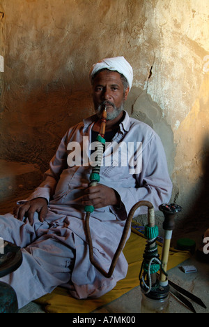 Egyptian man smoking a sheesha pipe, Siwa, Egypt Stock Photo
