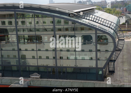 Cruise ship Aurora reflected in the windows of the cruise terminal building in Amsterdam Stock Photo