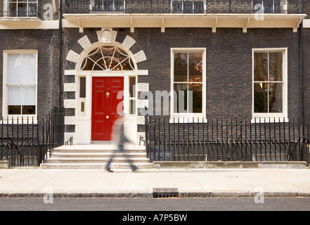Person walking along pavement at Bedford Square WC1 near Tottenham Court Road and Russell Square in London city England UK Stock Photo