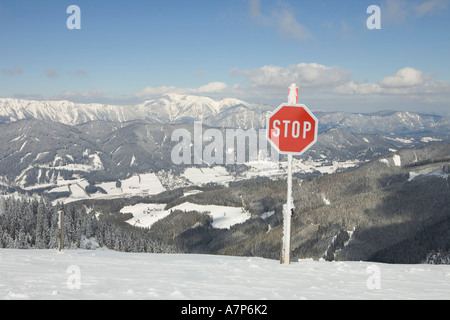 Stop sign and in the background the mountain Schneeberg ski area Stuhleck Styria Austria Stock Photo