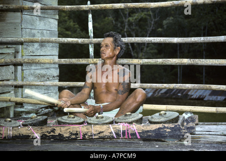 man with Gamelan in the longhouse Bunu of the Dayak Iban, Malaysia, Sarawak Stock Photo