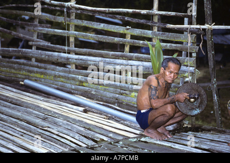 man with Gamelan in the longhouse Bunu of the Dayak Iban, Malaysia, Sarawak Stock Photo