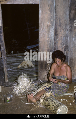 woman working in the longhouse Bunu of the Dayak Iban, Malaysia, Sarawak Stock Photo