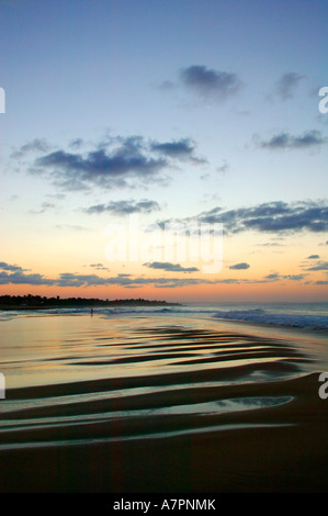 The Mozambique coast at sunset with the clouds mirrored in the wet ...