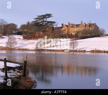 Fawsley Hall Hotel Daventry Northamptonshire from across the lake in winter Stock Photo