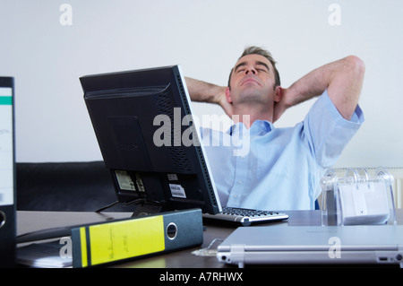 Businessman resting in office Stock Photo