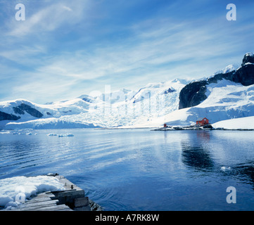 Snow covered mountain along sea, Paradise Bay, Antarctica Stock Photo