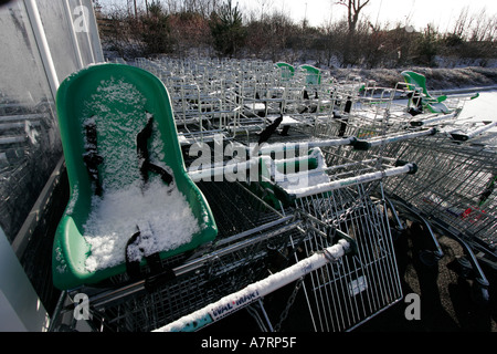 Child's seat and shopping trollies covered in snow Stock Photo