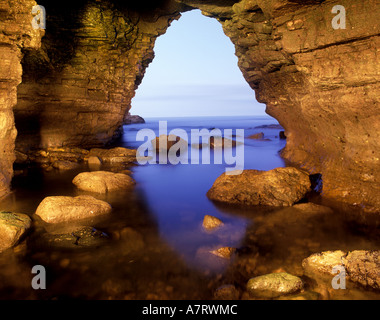 Limestone sea arch and cave at Marsden Bay on the South Tyneside coastline in the North East of England. Stock Photo