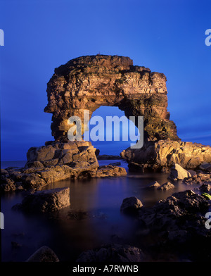 Limestone sea stack and arch at Marsden Bay on the South Tyneside coastline in the North East of England. Stock Photo