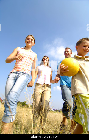 Low angle view of family walking in field Stock Photo