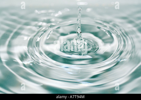 Close-up of water droplets creating ripples on water surface Stock Photo