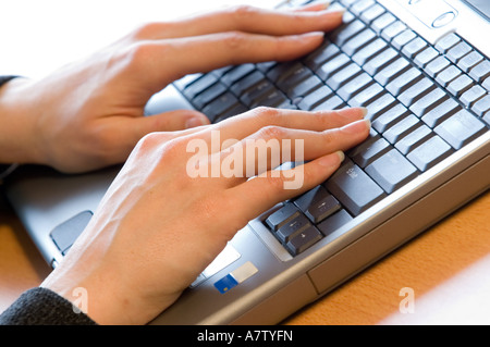 female hands on a keyboard of a laptop Stock Photo
