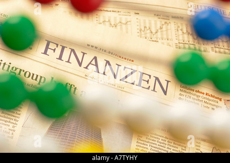 Close-up of beads of abacus with newspaper in background Stock Photo