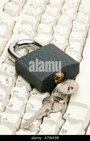 Computer keyboard digitally manipulated with key in lock - computer security concept. Stock Photo