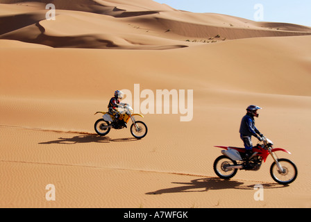 Two Moto Cross riders in sand dunes Erg Chebbi Merzouga Morocco Stock Photo