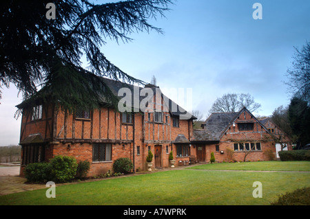 A LARGE TIMBER FRAMED HOME WITH RED BRICKS LAID PARTLY IN THE HERRINGBONE STYLE UK Stock Photo
