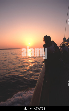 MALTA. A young couple enjoying a sunset boat trip along the Maltese coast. Stock Photo
