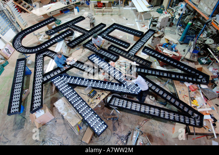 Giant cut outs of capital letters being fitted with lights by electricians Stock Photo