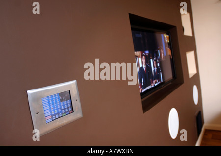 A CONTROL PANEL IN A SMART HOUSE WITH INTEGRATED SYSTEMS OF SECURITY AUDIO VISUAL HEATING AND LIGHTING UK Stock Photo