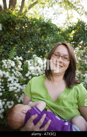 asian american mother breastfeeding infant baby outdoors Stock Photo