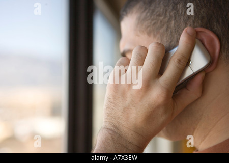 closeup of business man talking on cell phone in hotel room Stock Photo
