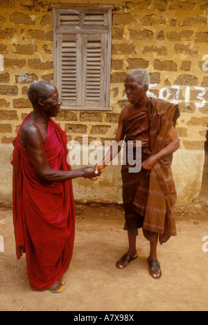 Ghana: Nsawkaw, Brong-Ahafo Region, uncles of Eric Nyamekye shaking hands, (L-R): Yaw Kontor, Kwame Badu, March. Stock Photo