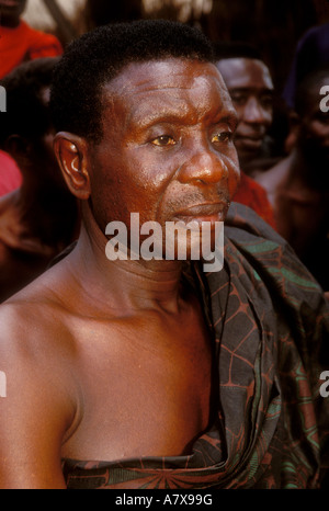 Ghana: Nsawkaw (Brong-Ahafo Region), village elder attending funeral wearing Adinkra cloth togo-style, March. Stock Photo