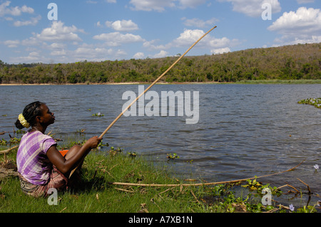 Woman fishing in Lake Ravelobe across from the Ampijeroa Forest Station. Ankarafantsika Nature Reserve, Western deciduous forest Stock Photo
