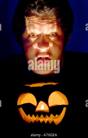 pumpkin blue eyes halloween moody scary dark dramatic orange pumpkin halloween jack o lantern moody dark scary evil halloween oc Stock Photo