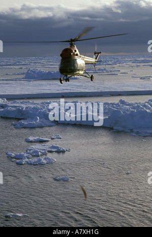 Antarctica, Helicopter over ice flow. Stock Photo